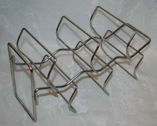 Here is a great, vintage, 5 bottle wine rack made out of Stainless steel. Stunning