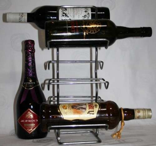 Here is a great, vintage, 5 bottle wine rack made out of Stainless steel. Stunning