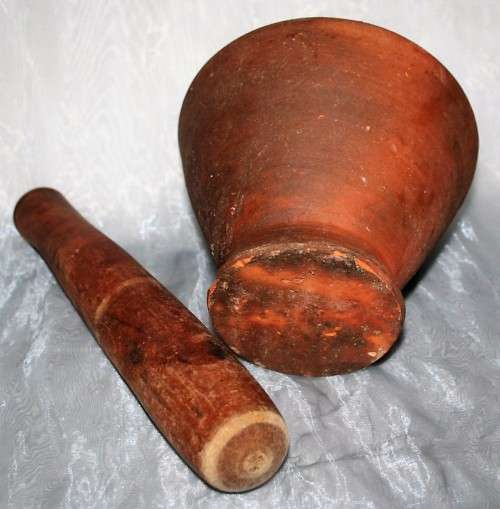 This is a beautiful antique Pottery mortar and pestle. It's handmade and hand carved - very useful