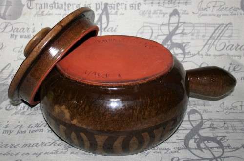 A Large vintage pottery bowl with a lid an explosion of color on both sides and a wonderful handle.