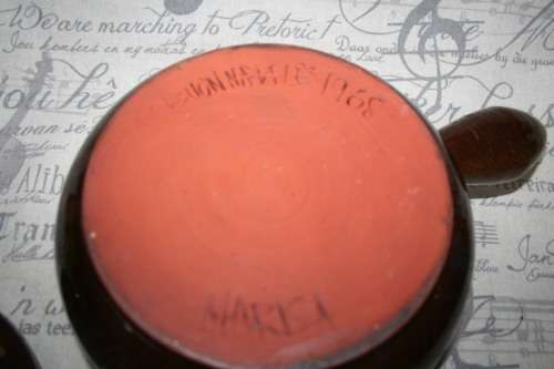 A Large vintage pottery bowl with a lid an explosion of color on both sides and a wonderful handle.