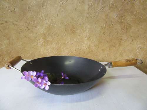 Large vintage steel wok with wooden handle. This is a very large and heavy duty wok.