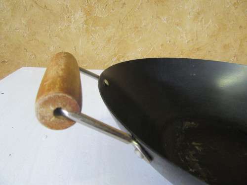 Large vintage steel wok with wooden handle. This is a very large and heavy duty wok.