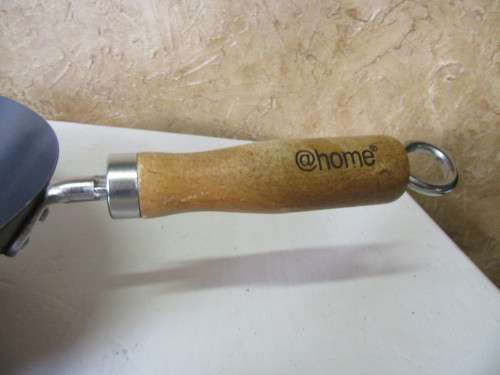 Large vintage steel wok with wooden handle. This is a very large and heavy duty wok.