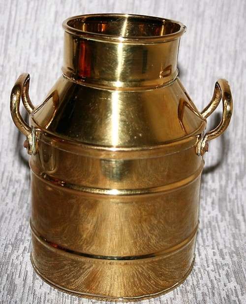 A gorgeous brass milk can clean and shiny will make a fantastic vase in that vintage shabby chic hou