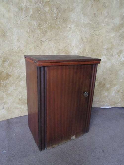 A VINTAGE BROTHER SEWING MACHINE IN A CUPBOARD IN WORKING CONDITION