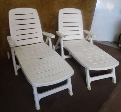 TWO FANTASTIC WHITE FOLD UP LOUNGERS ON WHEELS PERFECT FOR THIS SUMMER WEATHER BID PER EACH