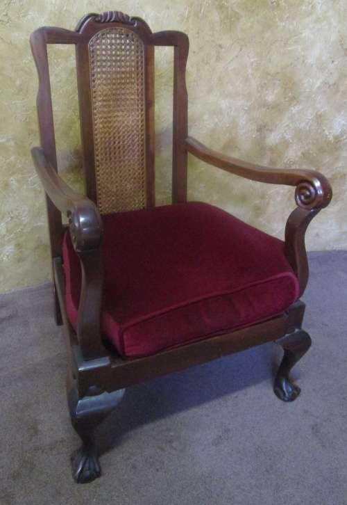 A GORGEOUS SOLID IMBUIA BOW BACKED BALL & CLAW ARM CHAIR WITH A RARE WEAVED RATTAN BACK