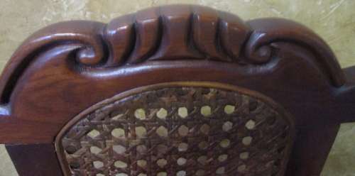 A GORGEOUS SOLID IMBUIA BOW BACKED BALL & CLAW ARM CHAIR WITH A RARE WEAVED RATTAN BACK