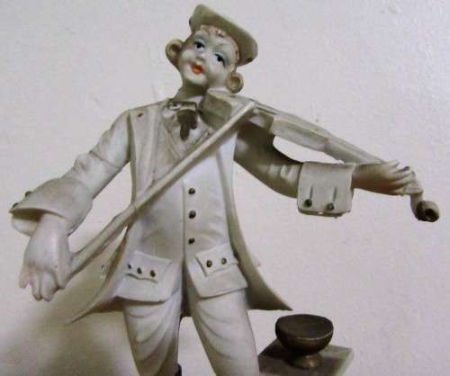 A DELIGHTFUL ITALIAN FIGURINE MOUNTED ON WOOD OF A MAN PLAYING THE VILON