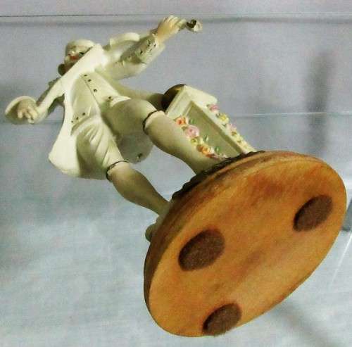 A DELIGHTFUL ITALIAN FIGURINE MOUNTED ON WOOD OF A MAN PLAYING THE VILON