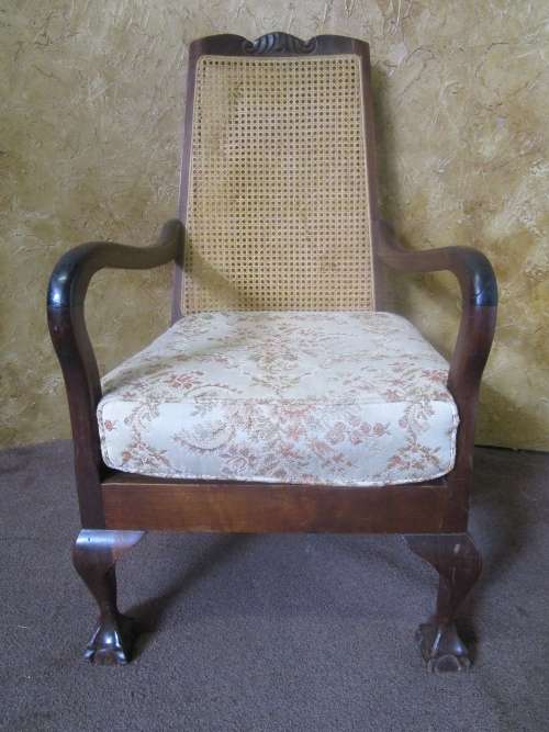 A GORGEOUS SOLID IMBUIA BOW BACKED BALL & CLAW ARM CHAIR WITH A RARE WEAVED RATTAN BACK