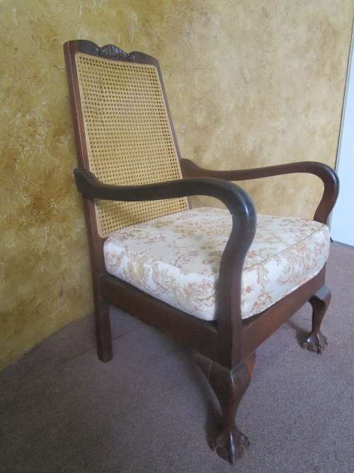 A GORGEOUS SOLID IMBUIA BOW BACKED BALL & CLAW ARM CHAIR WITH A RARE WEAVED RATTAN BACK