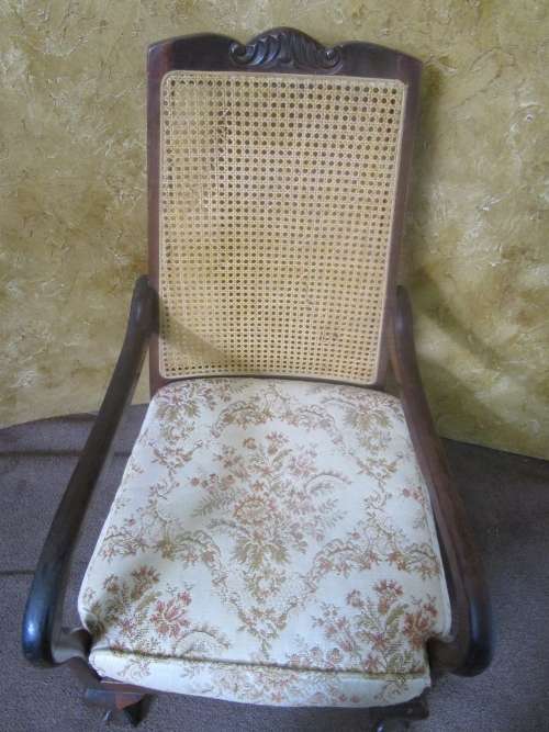 A GORGEOUS SOLID IMBUIA BOW BACKED BALL & CLAW ARM CHAIR WITH A RARE WEAVED RATTAN BACK