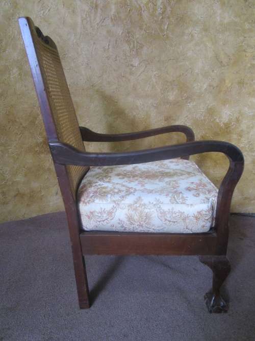 A GORGEOUS SOLID IMBUIA BOW BACKED BALL & CLAW ARM CHAIR WITH A RARE WEAVED RATTAN BACK