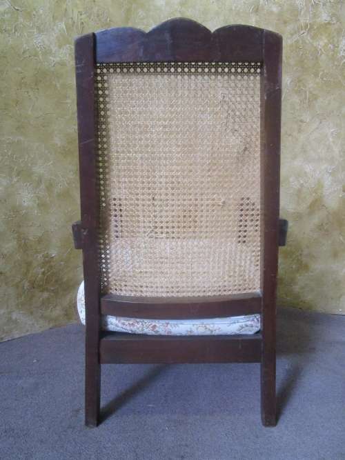 A GORGEOUS SOLID IMBUIA BOW BACKED BALL & CLAW ARM CHAIR WITH A RARE WEAVED RATTAN BACK