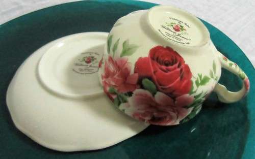 A STUNNING FLORAL VICTORIAN ROSE CUP & SAUCER BY WILLIAM JAMES -
