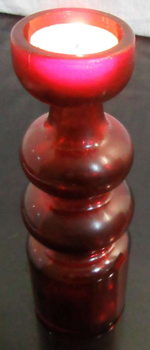 Very unusual red glass candle  holder or vase - pretty striking and different.