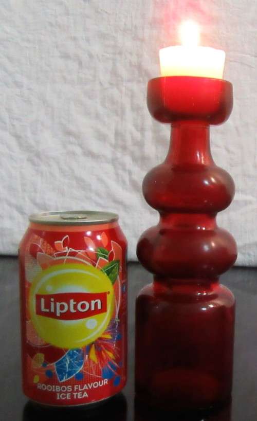 Very unusual red glass candle  holder or vase - pretty striking and different.