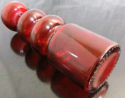 Very unusual red glass candle  holder or vase - pretty striking and different.