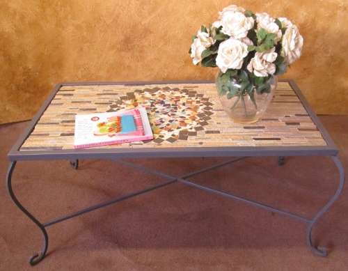 A GORGEOUS OUTDOOR TABLE WITH STEEL LEGS AND FRAME WITH A SOLLID MOSAIC TOP