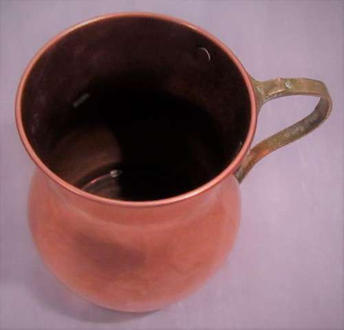 Four attractive antique tin-lined half pint copper mug or tankard with a brass handle.