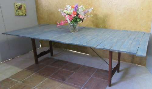A TRENDY 12 SEATER FOLD UP TABLE WITH A SOLID WOOD FRAME AND SHABBY CHIC TOP