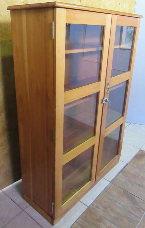 A STUNNING TWO DOOR SHOW/BOOK CASE FROM HEYSTECK RAND FURNITURE FACTORY A PRODUCT OF BOPHUTHATSWANA