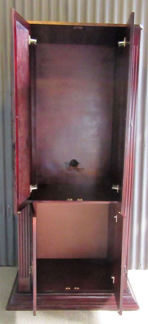 A ELGANT AND TALL FOUR DOOR CUPBOARD THAT CAN BE USE FOR TV OR LIQOUR CABINET WILL ALSO FOR OFFICE