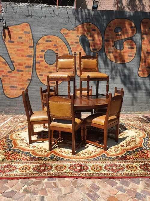 Stunning 8 seater Rhodesian Teak? Dining room table and chairs covered in leather.  R12950  +/- Heig