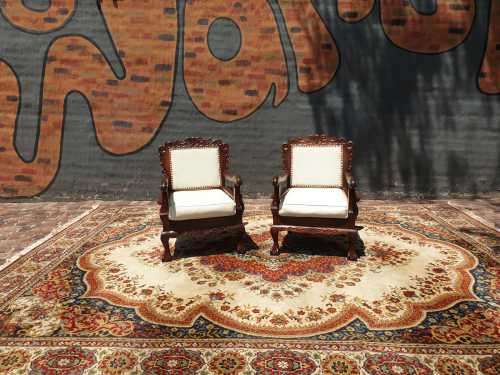 Pair of Beautifully carved  imbuia Ball and Claw Single Seaters armchairs good condition