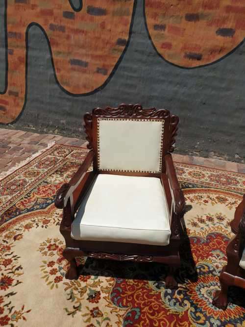 Pair of Beautifully carved  imbuia Ball and Claw Single Seaters armchairs good condition