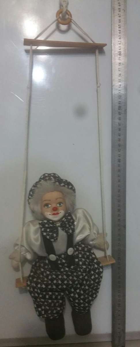 Amazing porcelline clown on a swing