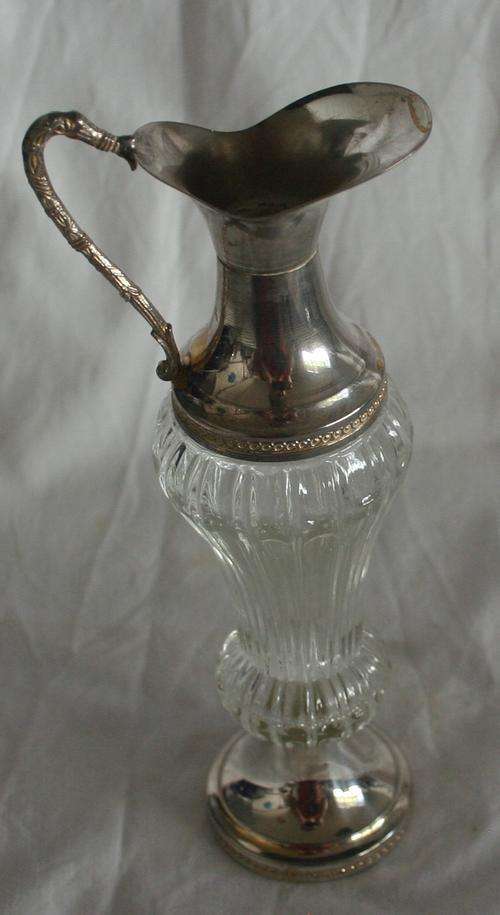 A SPECTACULAR CUT GLASS VINGAR DECANTER WITH SILVER METAL FINISH