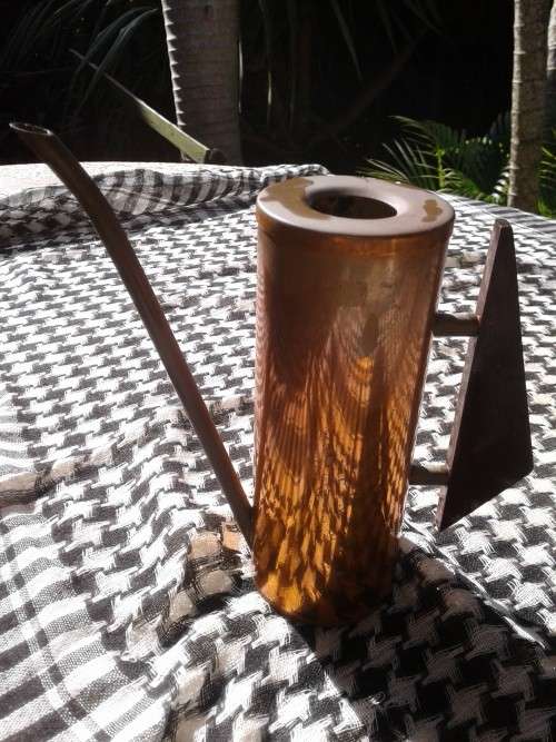 Copper watering can mounted triangular wooden handle