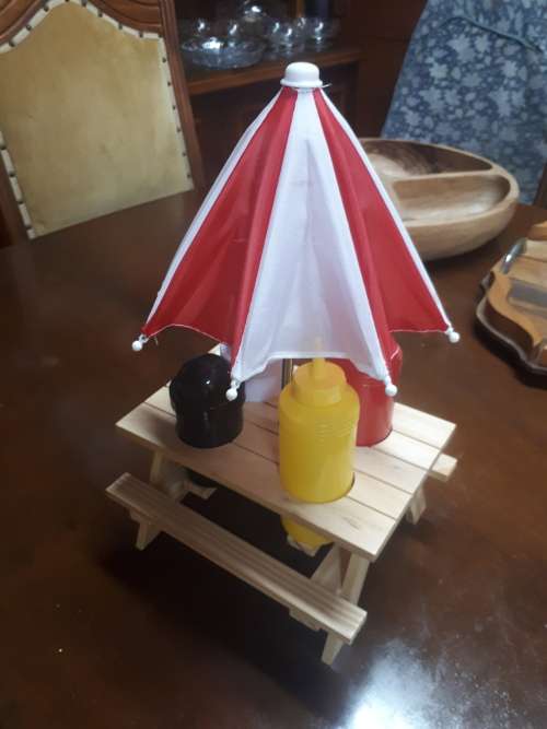Wooden Table With Umbrella Plastic Condiment Set Plus Two Sauce Bottles