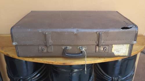 Very old brown expandable suitcase.