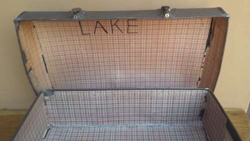 Very old brown expandable suitcase.