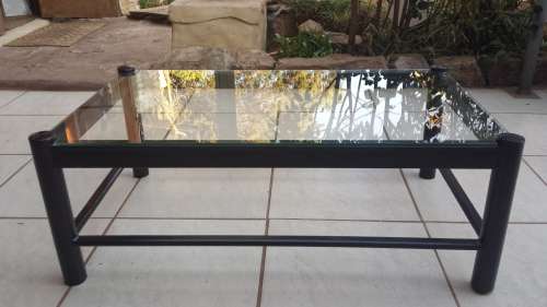 Black metal coffee table with glass top.