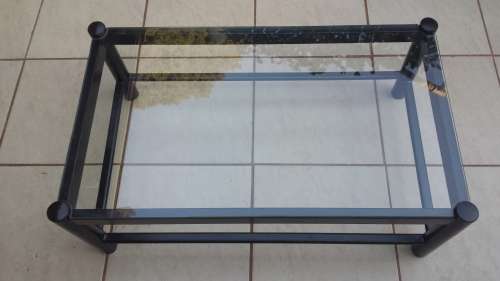 Black metal coffee table with glass top.