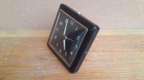 Old black alarm clock.