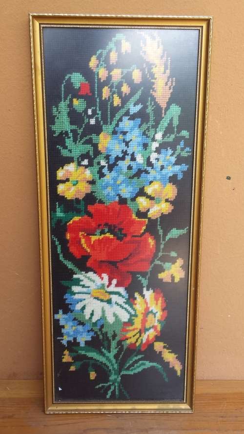 Small colourful framed tapestry.