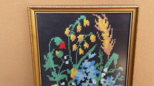 Small colourful framed tapestry.
