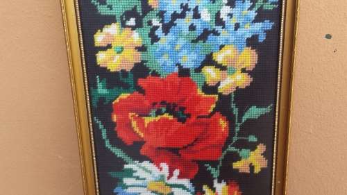 Small colourful framed tapestry.