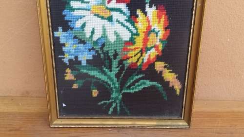Small colourful framed tapestry.