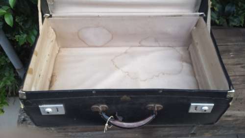 Old black, medium size suitcase.