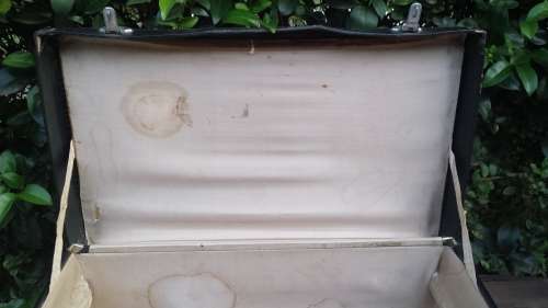 Old black, medium size suitcase.
