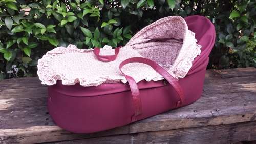 Old maroon baby carry cot.