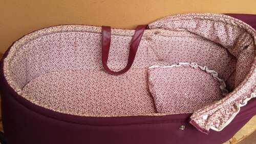 Old maroon baby carry cot.