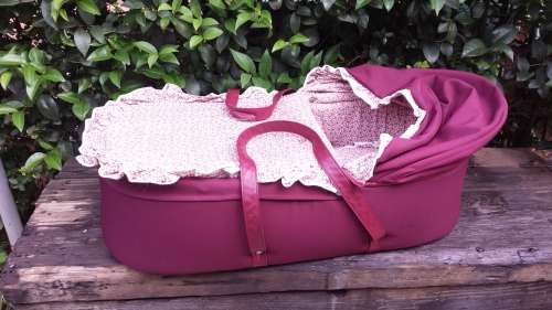 Old maroon baby carry cot.